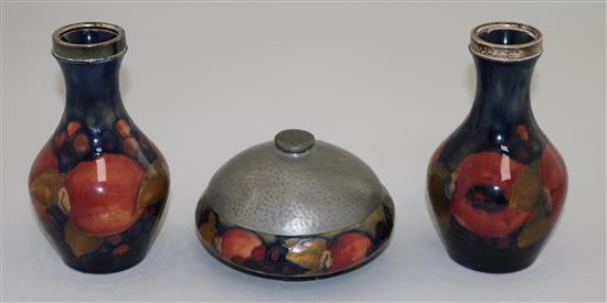 A pair of William Moorcroft Pomegranate pattern small vases, vases 14cm, bowl 20cm diameter